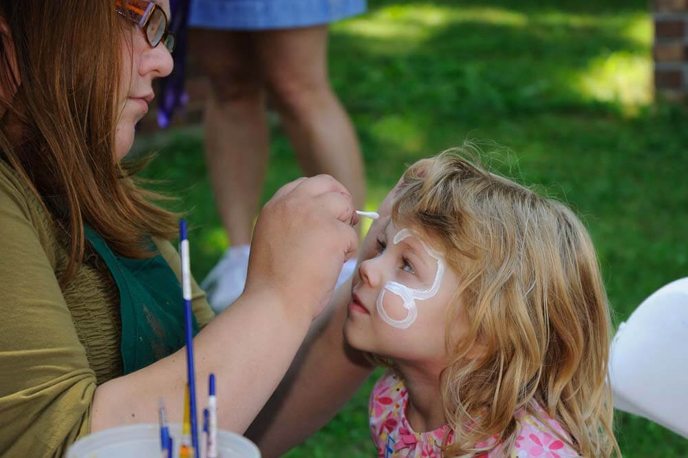 young girl getting her face painted