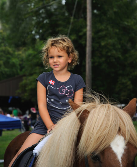 young girl riding pony