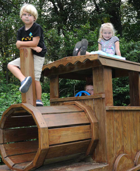 kids playing on wooden train