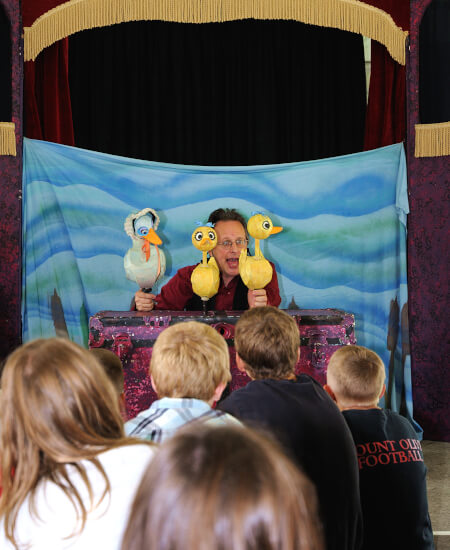 kids watching puppet show